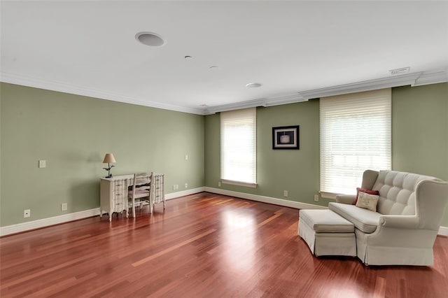 sitting room with wood-type flooring and ornamental molding