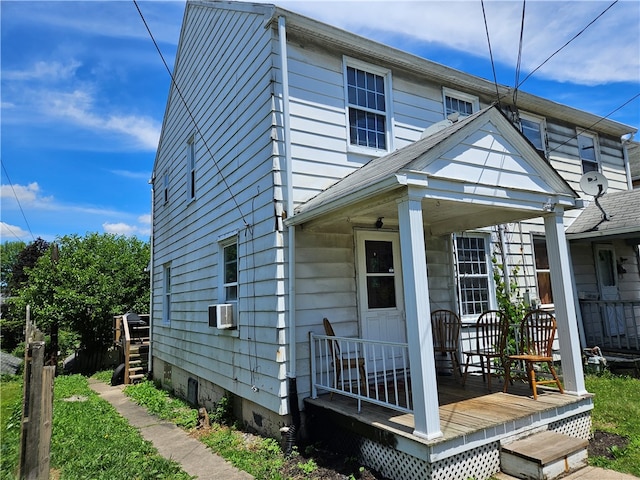 view of front of property with a porch and cooling unit