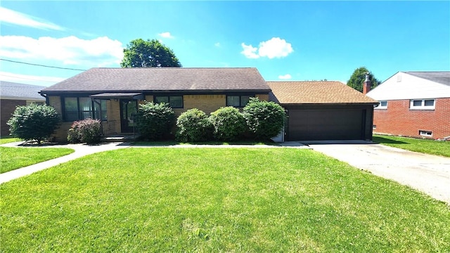 single story home featuring a garage and a front lawn