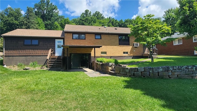 back of house with a wall mounted AC and a lawn