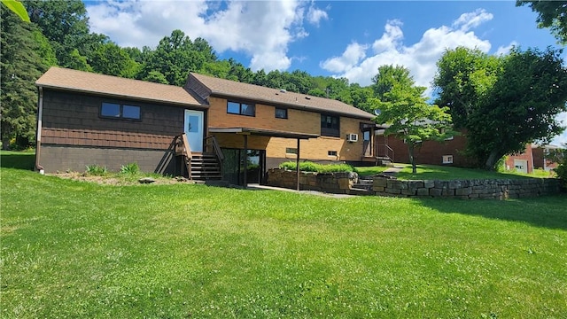 rear view of property with a lawn