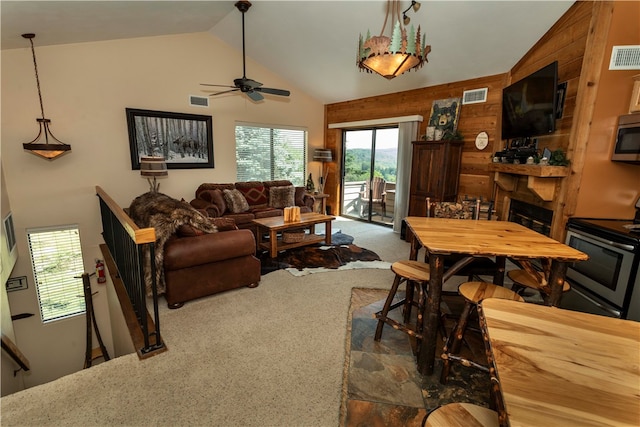 living room with carpet flooring, ceiling fan, a fireplace, and high vaulted ceiling