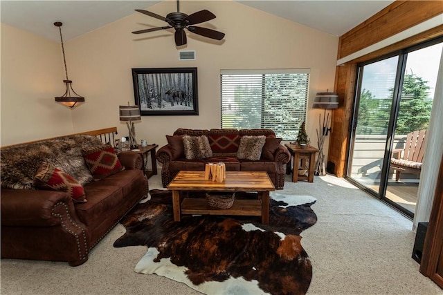 carpeted living room with a healthy amount of sunlight, a ceiling fan, and lofted ceiling