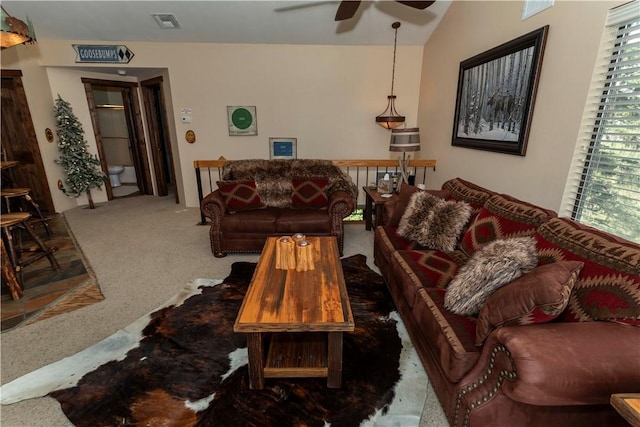 living area featuring visible vents, a ceiling fan, and carpet flooring