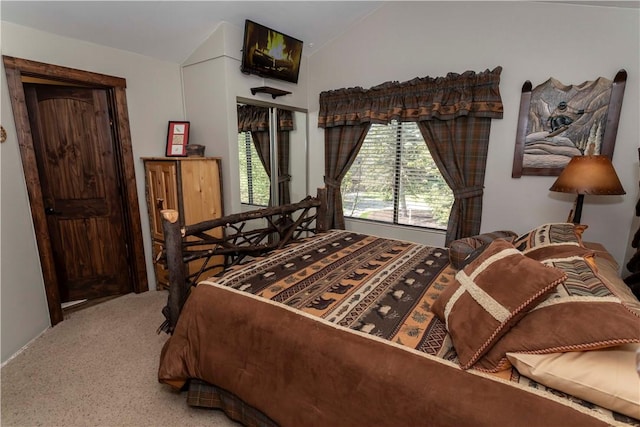 carpeted bedroom featuring vaulted ceiling