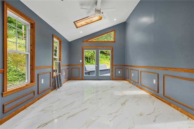 tiled spare room featuring high vaulted ceiling and ceiling fan