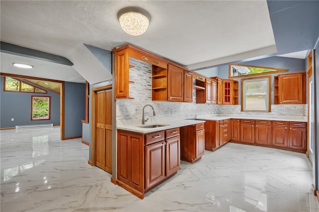 kitchen with sink, backsplash, light tile floors, and a textured ceiling