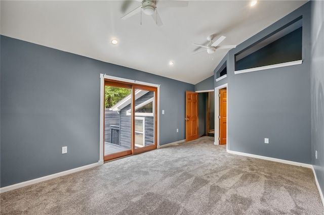 spare room with vaulted ceiling, carpet, and ceiling fan