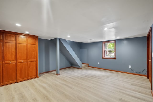 basement with light hardwood / wood-style flooring