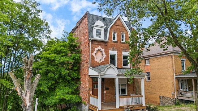 back of property with a porch