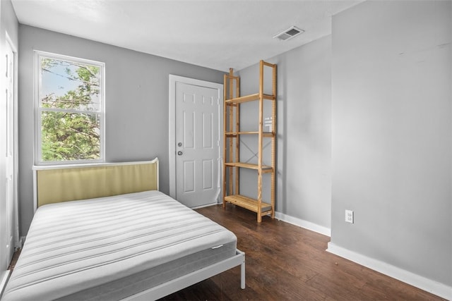 bedroom featuring dark hardwood / wood-style flooring