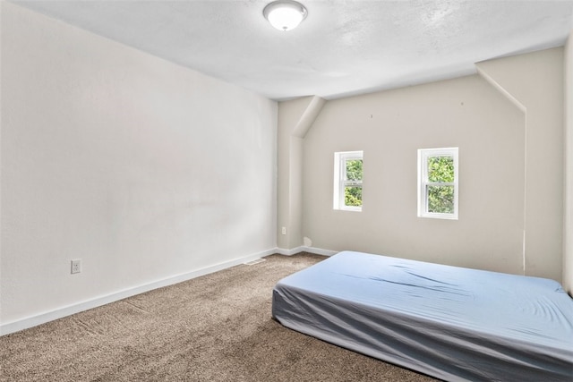 carpeted bedroom featuring vaulted ceiling