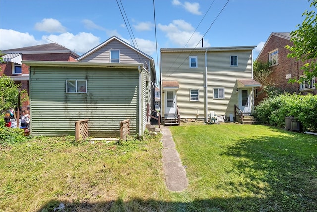 back of house with a lawn