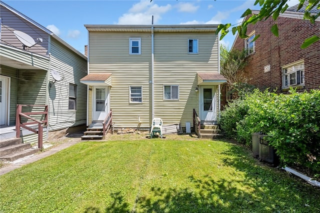 rear view of property featuring a yard