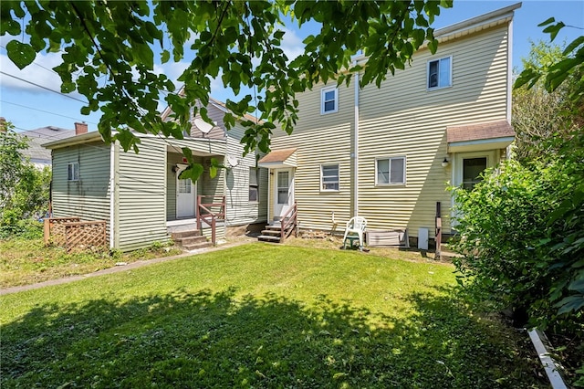 rear view of property with a lawn