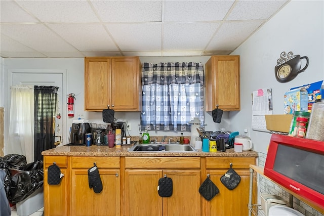 kitchen featuring sink and a drop ceiling