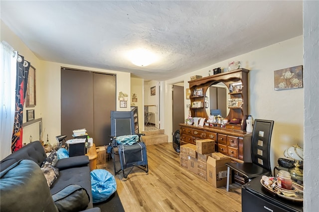 living room with wood-type flooring and a textured ceiling