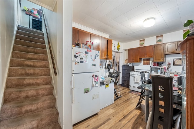 kitchen featuring white appliances and light wood-type flooring