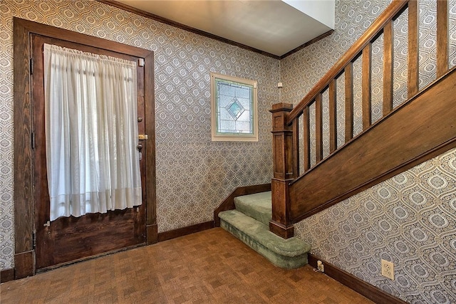 foyer featuring carpet floors and crown molding