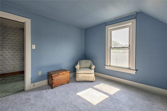 unfurnished room with lofted ceiling and carpet floors