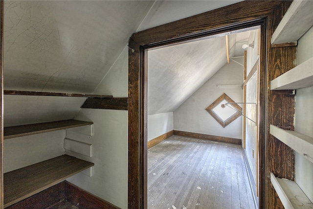 bonus room featuring vaulted ceiling and hardwood / wood-style flooring