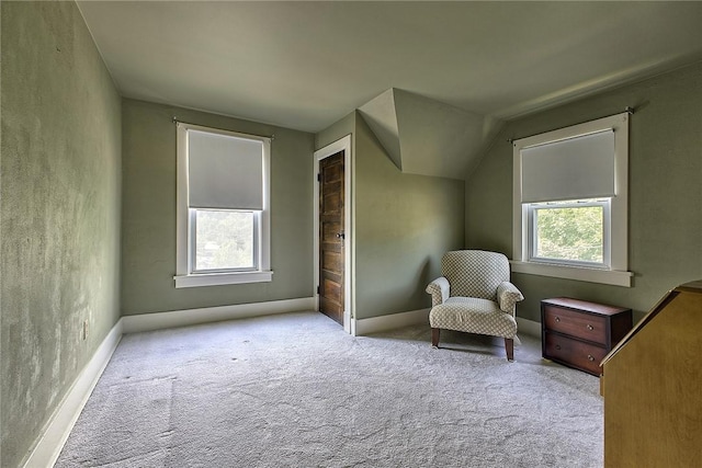 unfurnished room with vaulted ceiling and carpet floors