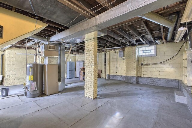 basement featuring heating unit and gas water heater