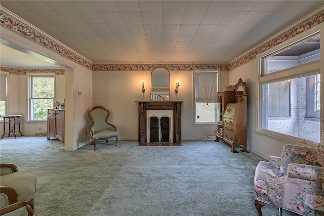 carpeted living room with ornamental molding