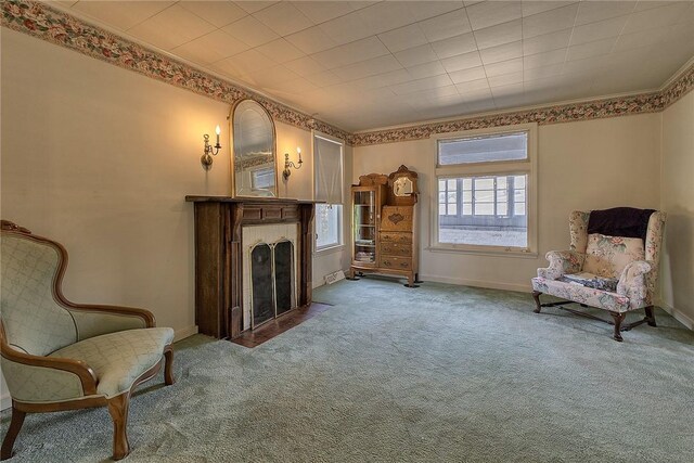 living area with crown molding and carpet flooring