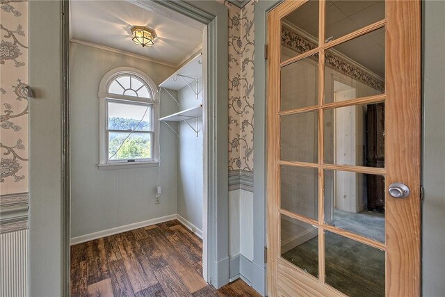 interior space with ornamental molding and dark wood-type flooring