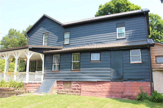 rear view of house featuring covered porch