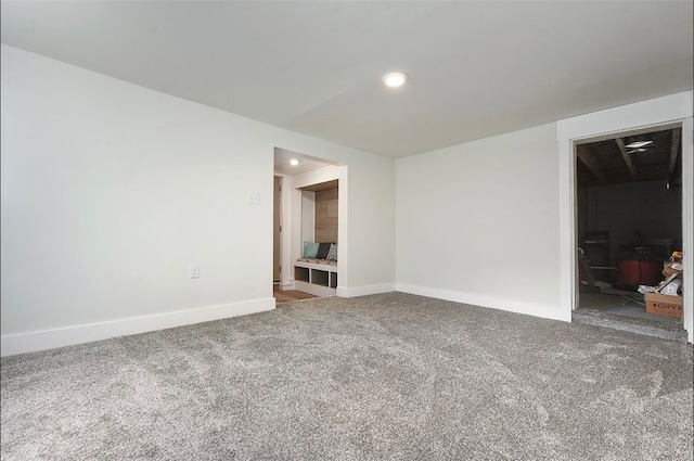 carpeted spare room featuring recessed lighting and baseboards