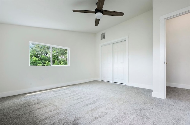 unfurnished bedroom featuring visible vents, baseboards, ceiling fan, carpet flooring, and a closet