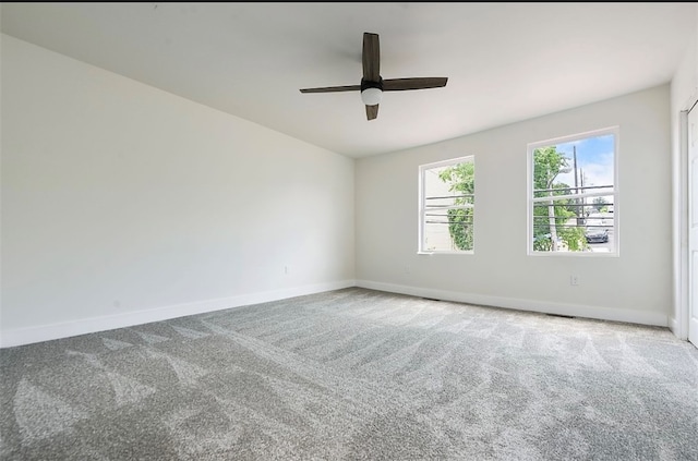 carpeted spare room featuring ceiling fan