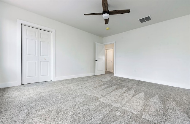 unfurnished bedroom with baseboards, visible vents, carpet floors, and a closet