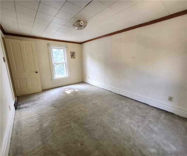 carpeted empty room featuring crown molding