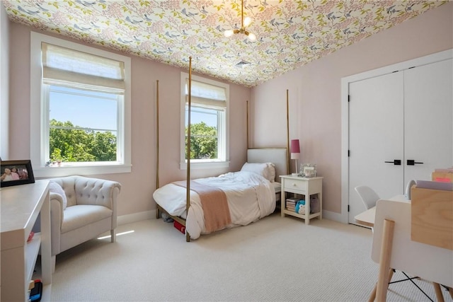 bedroom with light carpet and a closet