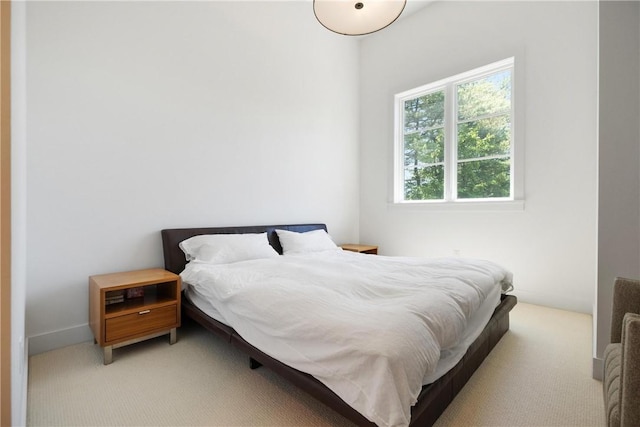 bedroom featuring light colored carpet