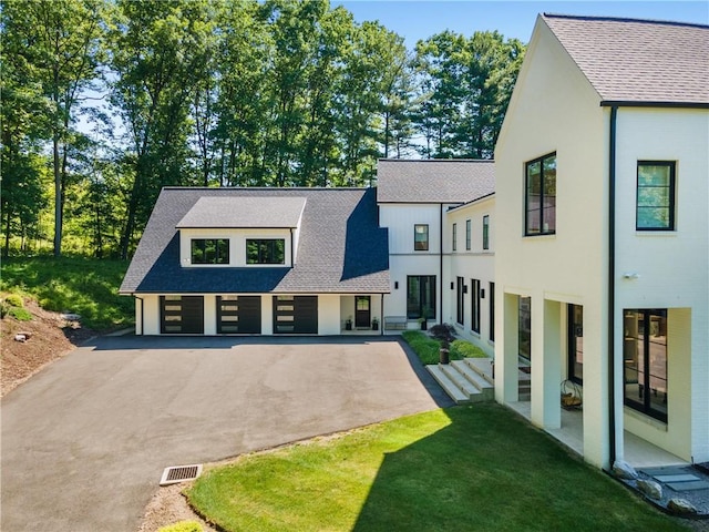107 Nantucket Dr, Fox Chapel, PA 15238 - view of front of house with a shingled roof, asphalt driveway, a garage, and a front lawn