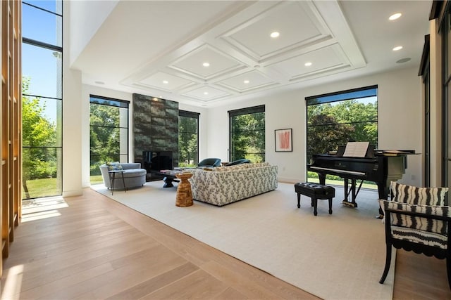 living room featuring light hardwood / wood-style floors and coffered ceiling