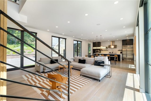 living room featuring light hardwood / wood-style flooring and sink