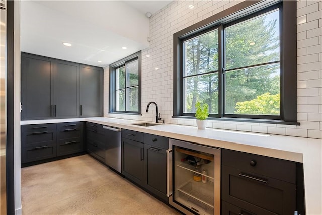 kitchen featuring dishwasher, wine cooler, a wealth of natural light, and sink