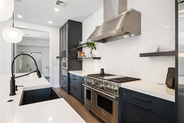 kitchen featuring pendant lighting, sink, stainless steel appliances, and range hood