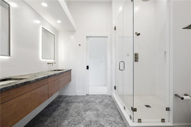 bathroom featuring vanity and a shower with door