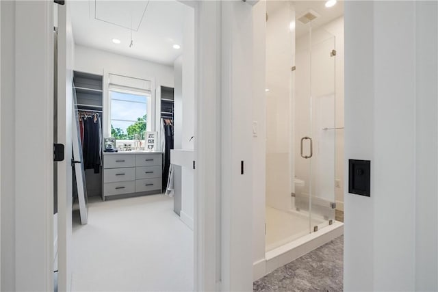 bathroom with toilet and an enclosed shower