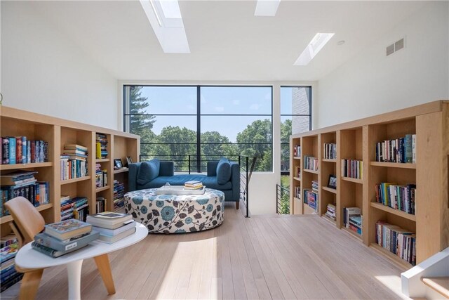 107 Nantucket Dr, Fox Chapel, PA 15238 - sitting room featuring a skylight, floor to ceiling windows, healthy amount of natural light, and wood finished floors