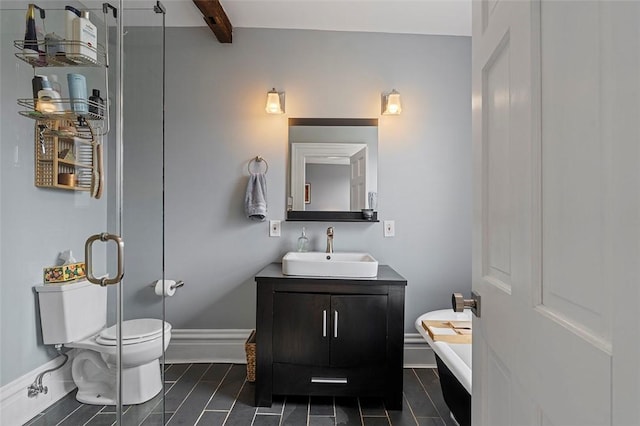 bathroom featuring vanity, beam ceiling, and toilet