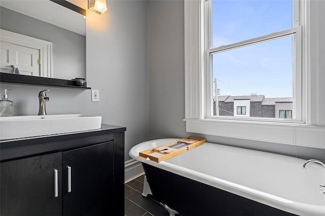 bathroom with vanity, tile patterned floors, and a bathing tub