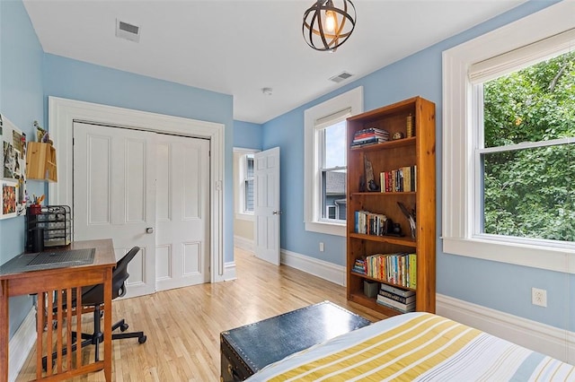 bedroom with a closet and light hardwood / wood-style flooring