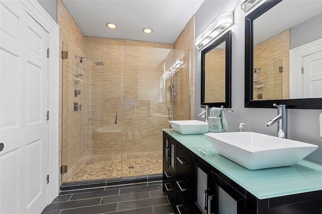 bathroom featuring tile patterned floors, vanity, and walk in shower